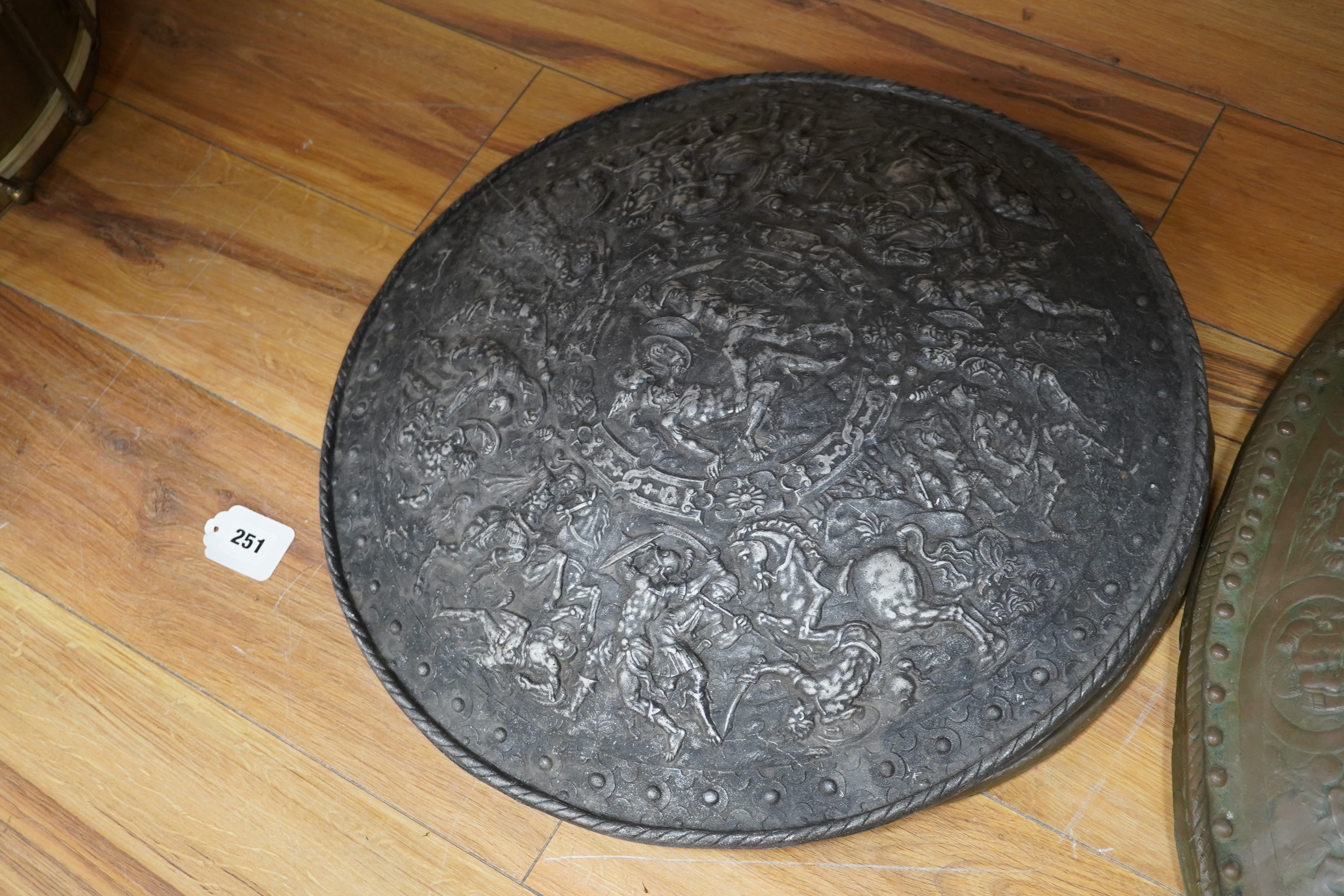 Three metal castings of decorative embossed shields, decorated with battle scenes, ancient armour, etc., diameter of largest 51.5cm. Condition - fair